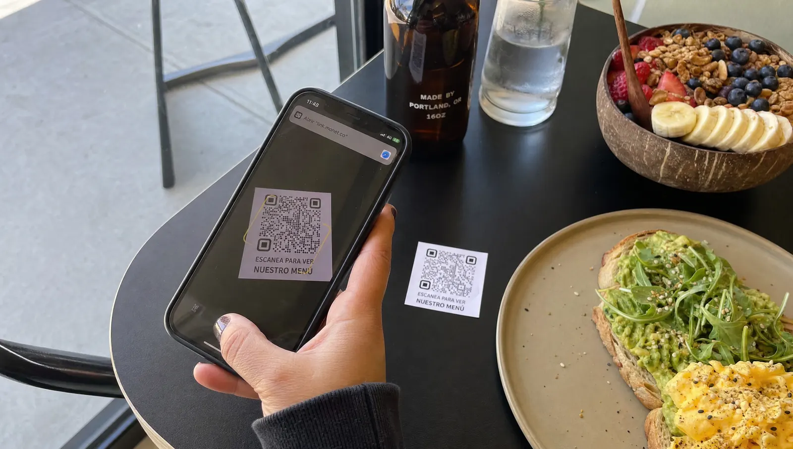 Cliente escaneando con el móvil el código QR de la carta en una mesa de brunch